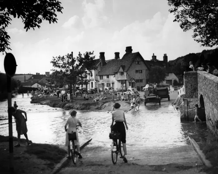 Framed Print : Families play in the flood water in Eynsford Kent. Some of the children paddle others Framed Print : Families play in the flood water in Eynsford Kent. Some of the children paddle others
