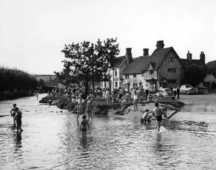 Framed Print : Families play in the flood water in Eynsford, Kent. Some of the children paddle others Framed Print : Families play in the flood water in Eynsford, Kent. Some of the children paddle others