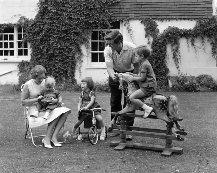 Framed Print : Family in the garden with mother with toddler on her lap, girl on a tricycle Framed Print : Family in the garden with mother with toddler on her lap, girl on a tricycle