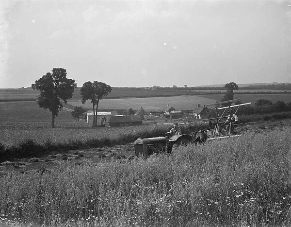 A farmer collects his harvest with his combine in Dene Bottom. March 1938