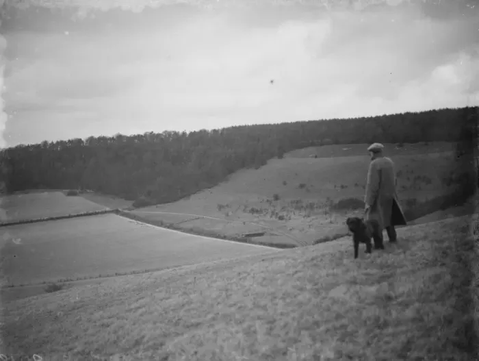 Framed Print : A farmer and his dog stands to view his fields at Preston hill farm estate