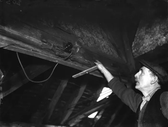 Framed Print : A farmer points out an electric switch on the beams in the old forge Framed Print : A farmer points out an electric switch on the beams in the old forge