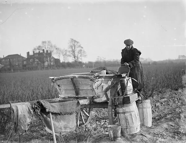 A farmer refills his barrels with fruit spray. 1936