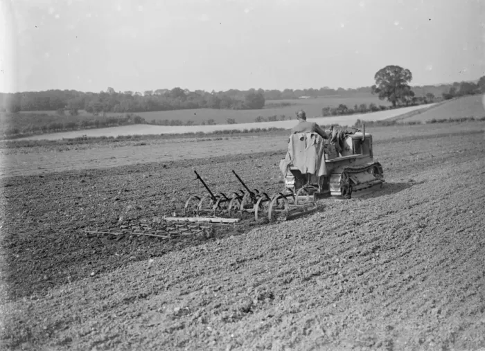 Framed Print : A farmer and his tank track tractor cultivates a field. 1935 Framed Print : A farmer and his tank track tractor cultivates a field. 1935