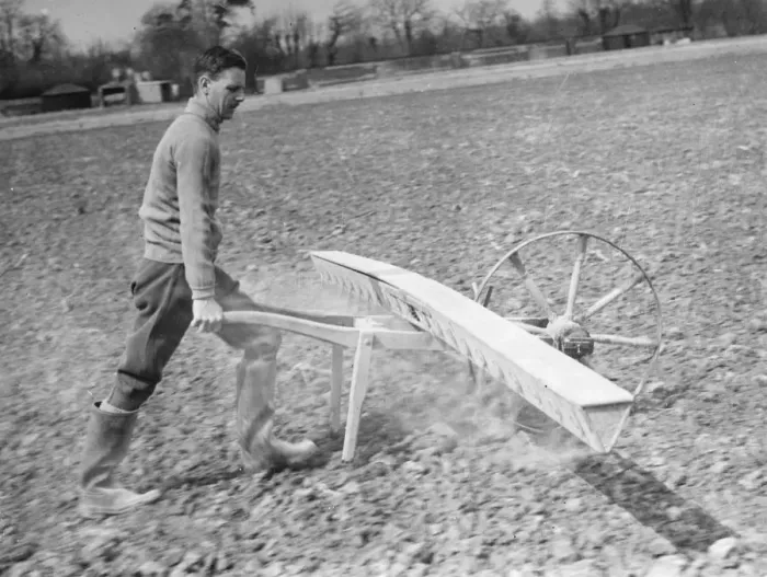 Framed Print : Farmer using a Coopers Drymac seed barrow. 1937
