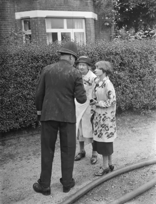 Framed Print : Firemen respond to a house fire in Chislehurst, Kent. A policeman speaks to Mrs