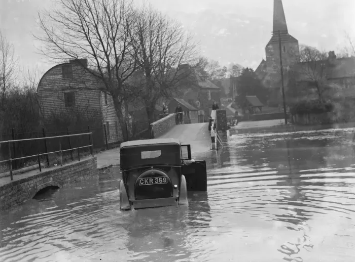 Framed Print : Flooding in Eynsford, Kent. Motorist tries to navigate through the flooded street Framed Print : Flooding in Eynsford, Kent. Motorist tries to navigate through the flooded street