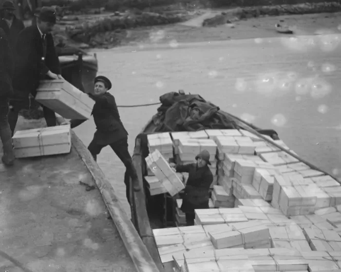 Framed Print : The flower harvest in the Scilly Islands. Loading the flowers into boats at Tresco Framed Print : The flower harvest in the Scilly Islands. Loading the flowers into boats at Tresco