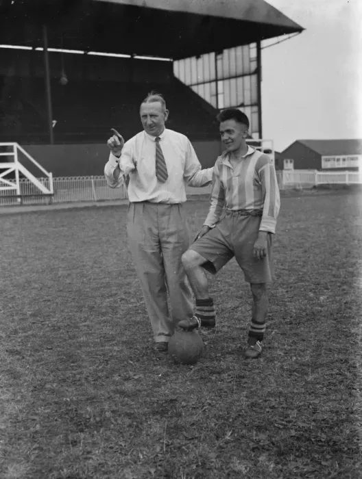 Framed Print : Footballers at Dartford. A manager talks tactics to one of his players