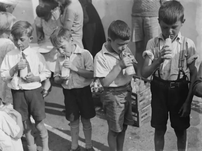 Framed Print : Free milk for children on holiday in Crayford, Kent. Boys stand in a row sipping