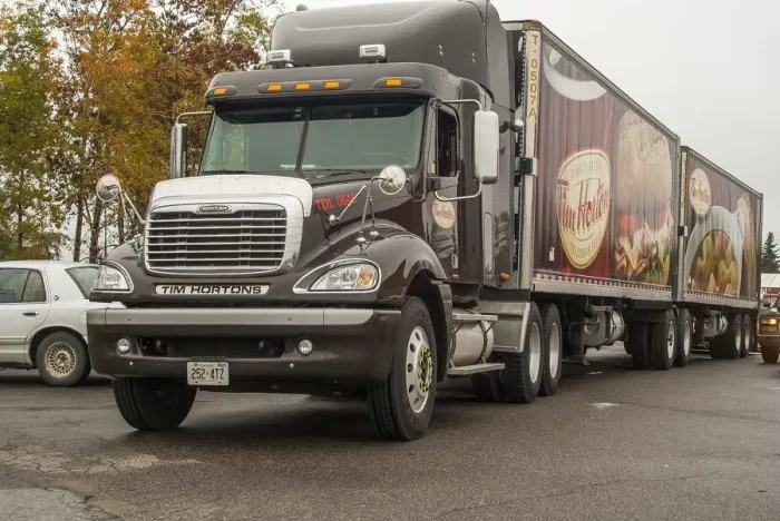 Framed Print : A freightliner 6x4 artic unit, hauling for the Canadian icon, Tim Hortons coffee