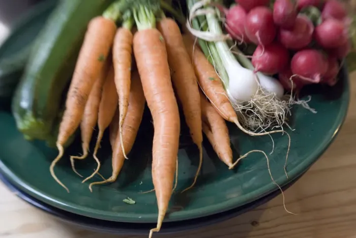 Framed Print : Fresh vegetables from farmers market on dark green platter credit: Marie-Louise