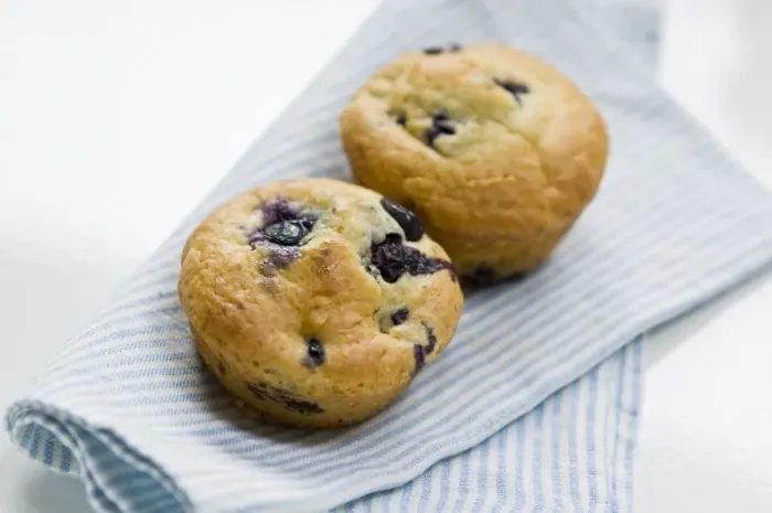 Framed Print : Freshly baked blueberry muffin on blue striped napkin. credit: Marie-Louise Avery Framed Print : Freshly baked blueberry muffin on blue striped napkin. credit: Marie-Louise Avery