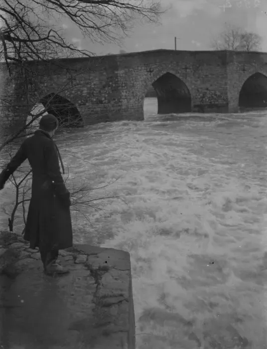Framed Print : A full, rushing river at the ancient stone bridge at Yalding in Kent after flooding