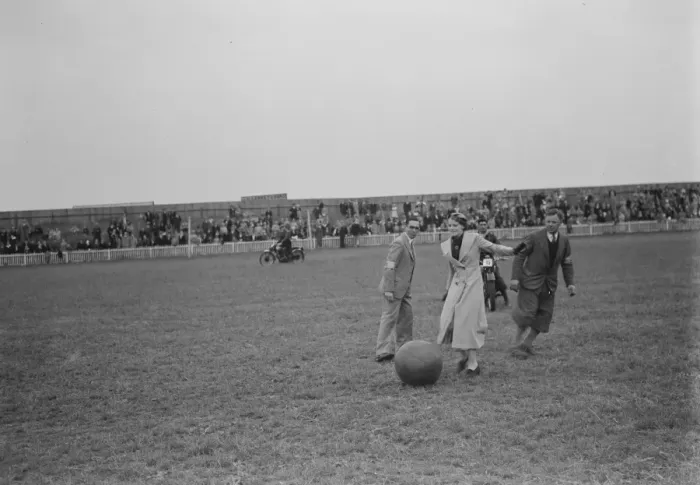 Framed Print : The Gravesend and District Motor Cycle Gymkhana in Kent. A woman kicking a ball around