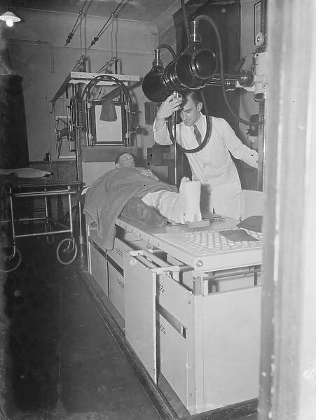 Gravesend Hospital in Kent. The X-ray department. A patient has a scan of his