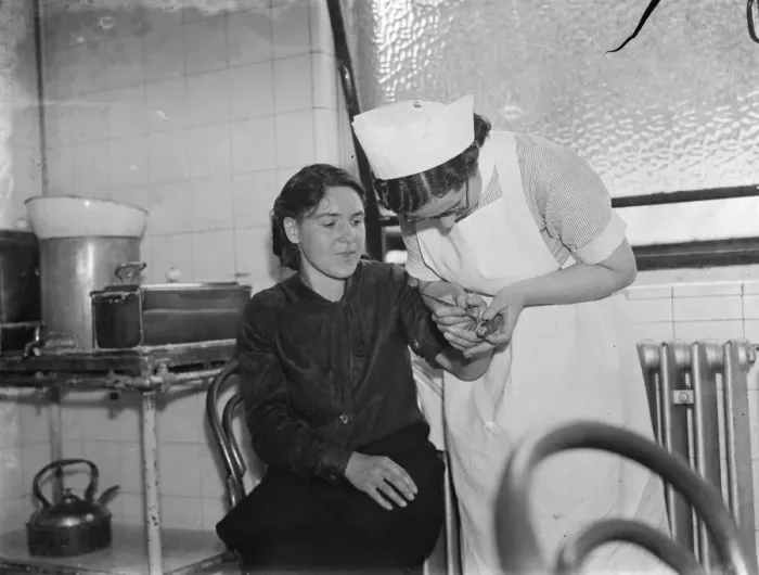 Framed Print : Gravesend hospital series. Nurse tending to a casualty. 1939 Framed Print : Gravesend hospital series. Nurse tending to a casualty. 1939