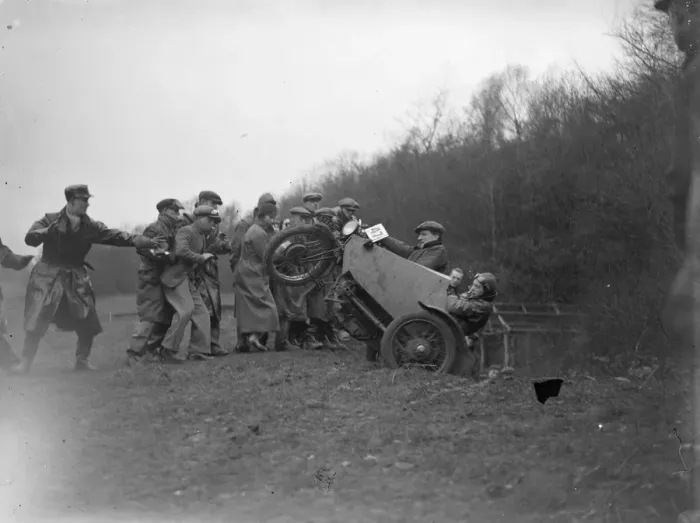 Framed Print : A group of men pull a motorbike out of a ditch after it lost control during the race