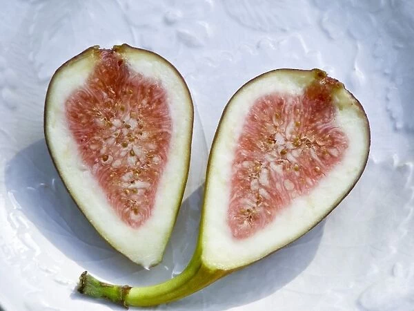 Halved ripe fig on white plate credit: Marie-Louise Avery  /  thePictureKitchen  /  TopFoto