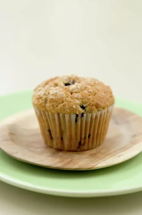 Framed Print : Healthy bran and raisin muffin on small wooden plate on green platter credit: Marie-Louise Framed Print : Healthy bran and raisin muffin on small wooden plate on green platter credit: Marie-Louise