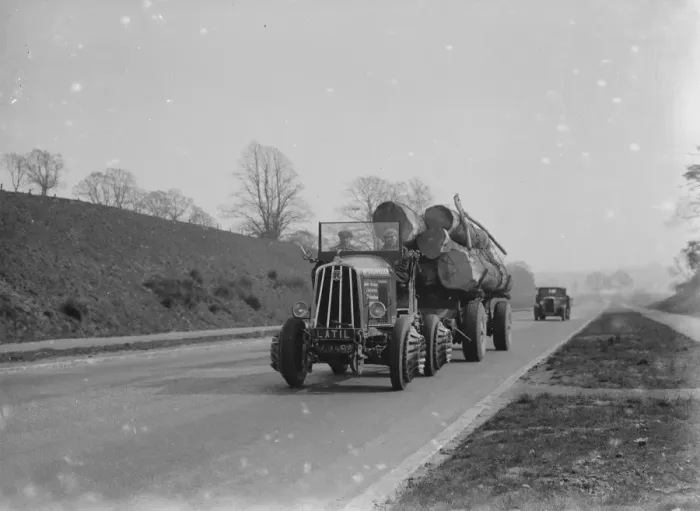 Framed Print : Heavy load of logs being towed by a tractor. 1935 Framed Print : Heavy load of logs being towed by a tractor. 1935