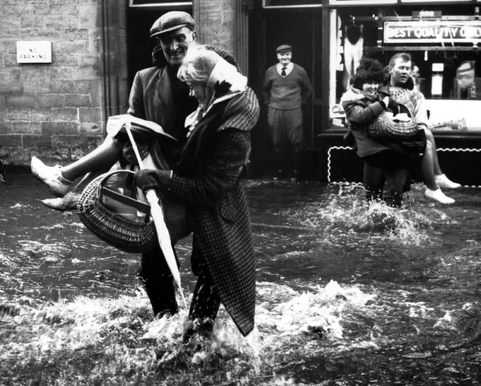 Framed Print : Helping hands in the Northern Floods office girls were carried through flood waters