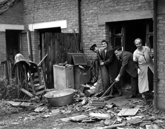 Framed Print : Home front 1940 A bus driver cleans debris from an air raid up before reporting