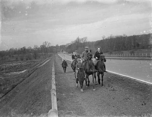 Horse riders ride on the path down the bypass road. 1936