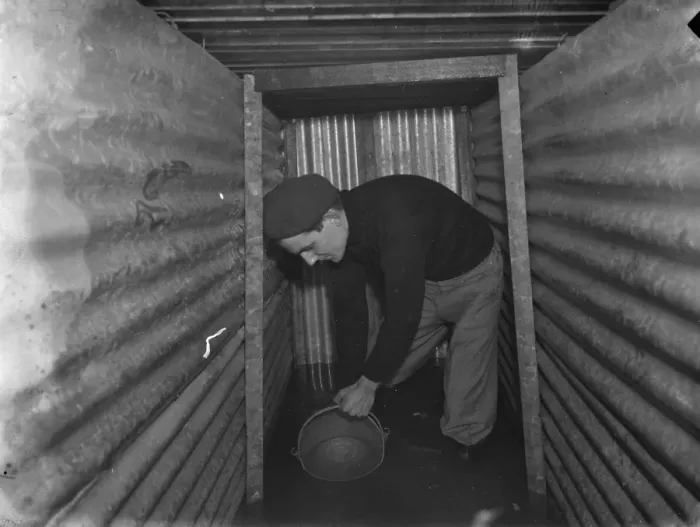 Framed Print : The interior of a flooded dug out in Sidcup, Kent. Mr George Harris attempts Framed Print : The interior of a flooded dug out in Sidcup, Kent. Mr George Harris attempts