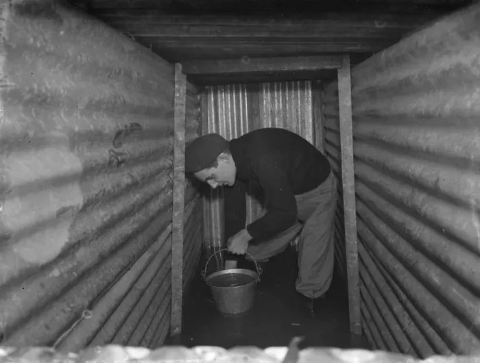 Framed Print : The interior of a flooded dug out in Sidcup, Kent. Mr George Harris attempts Framed Print : The interior of a flooded dug out in Sidcup, Kent. Mr George Harris attempts