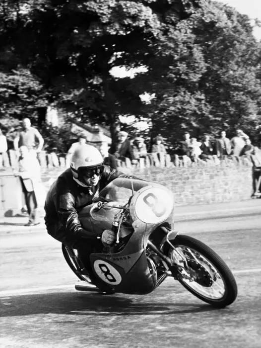 Framed Print : Isle of Man: N Taniguchi of Japan takes the corner at speed, riding a 125cc Japanese honda Framed Print : Isle of Man: N Taniguchi of Japan takes the corner at speed, riding a 125cc Japanese honda
