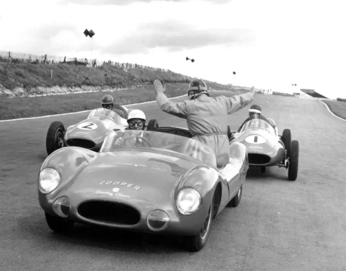 Framed Print : John Cooper, back to camera, instructs from a Cooper car driven by Les Leston as Framed Print : John Cooper, back to camera, instructs from a Cooper car driven by Les Leston as