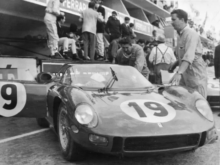 Framed Print : John Surtees bends under the driving wheel of his Ferrari here last night after he Framed Print : John Surtees bends under the driving wheel of his Ferrari here last night after he