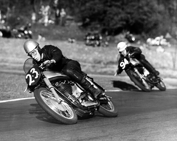 John Surtees compact crouch helps to streamline him at top speed. Here he corners
