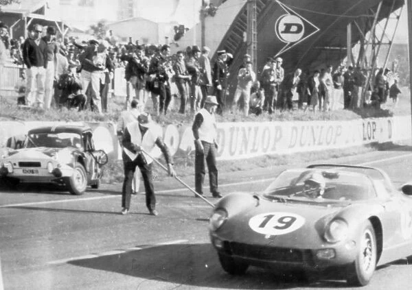 John Surtees in his Ferarri leading after 33 laps flashing past Mike Rothschild s