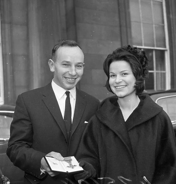 John Surtees with Miss Patricia Burke outside Buckingham Palace after he collected