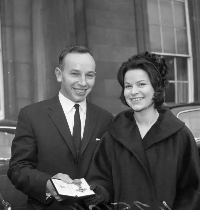 Framed Print : John Surtees with Miss Patricia Burke outside Buckingham Palace after he collected