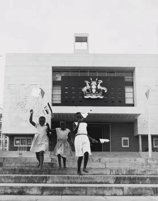 Framed Print : Kampala, Uganda, three young girls run down the steps in front of the new parliament Framed Print : Kampala, Uganda, three young girls run down the steps in front of the new parliament