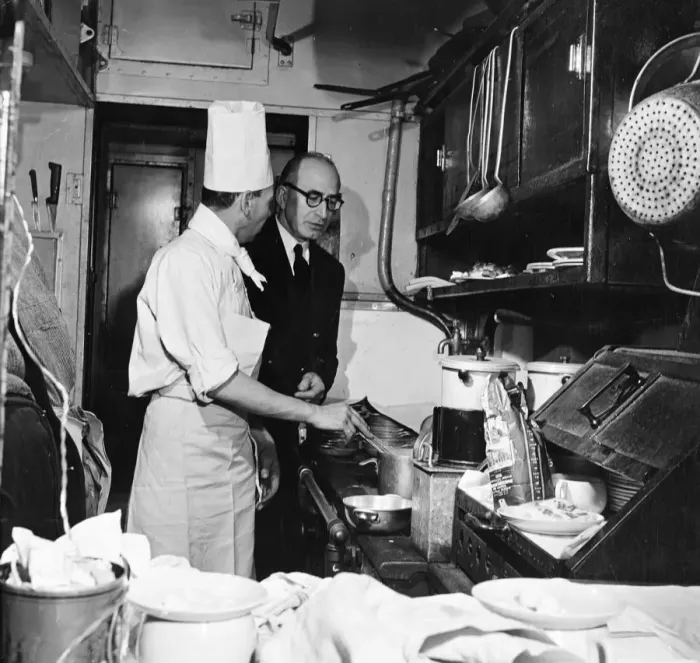 Framed Print : In the kitchen of the restaurant car, the chef M. Roche consults the Maitre d Hotel about breakfast