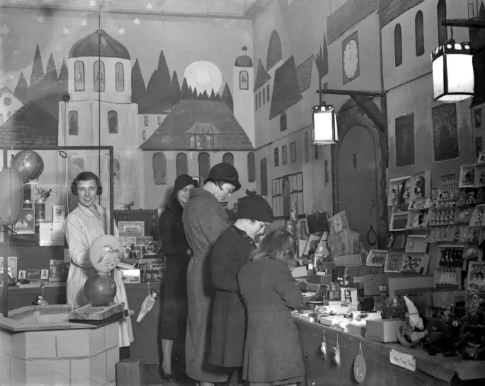Framed Print : Lady Verney (striped scarf) in the toy and bookshop she has opened in the garage Framed Print : Lady Verney (striped scarf) in the toy and bookshop she has opened in the garage