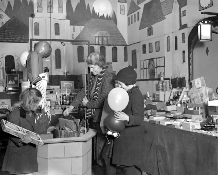 Framed Print : Lady Verney (striped scarf) in the toy and bookshop she has opened in the garage Framed Print : Lady Verney (striped scarf) in the toy and bookshop she has opened in the garage