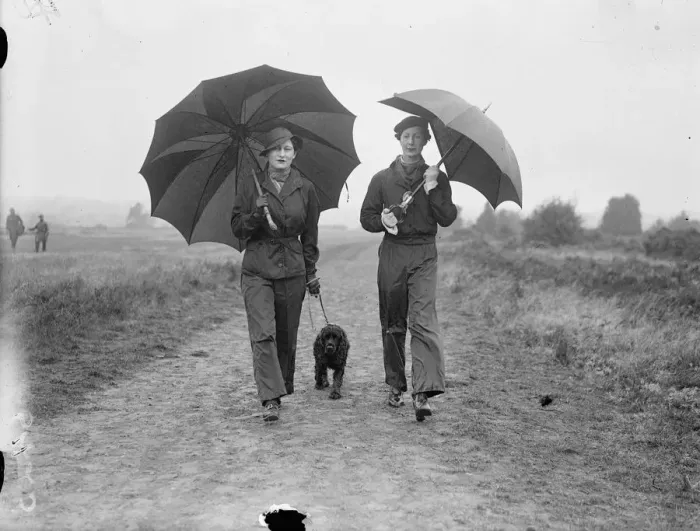 Framed Print : Lady Waleran (left) and Mrs Locker Lampson wearing waterproof trousers and carrying Framed Print : Lady Waleran (left) and Mrs Locker Lampson wearing waterproof trousers and carrying