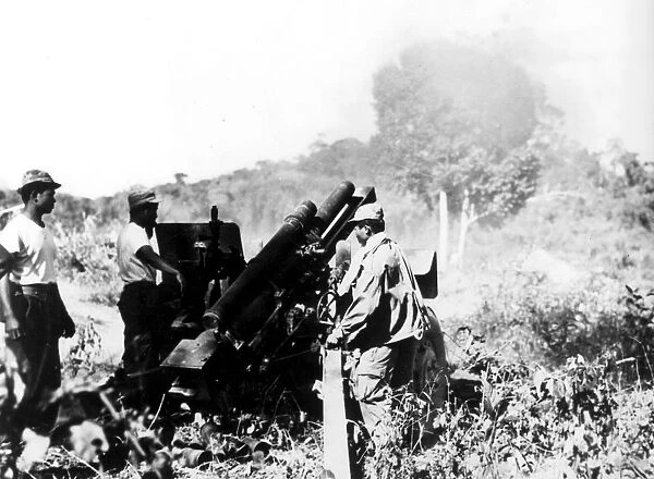 Laos: Royal laotian artillerymen fire a 105mm. Howitzer against a rebel position