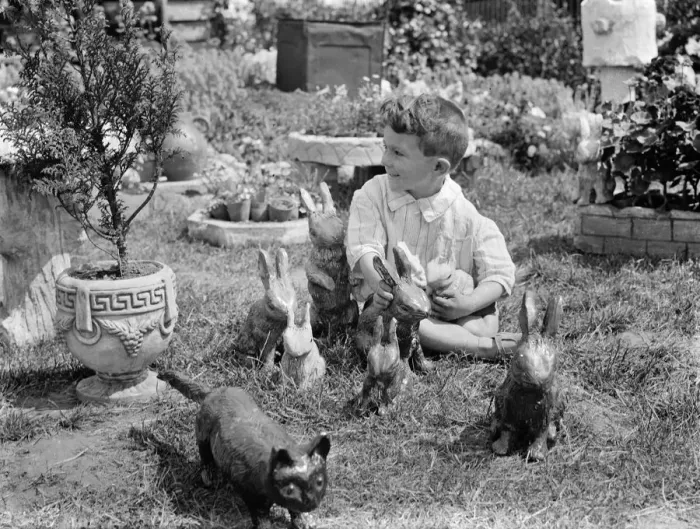 Framed Print : A little boy with some of the clay rabbits made by Mr Sadler. 1938