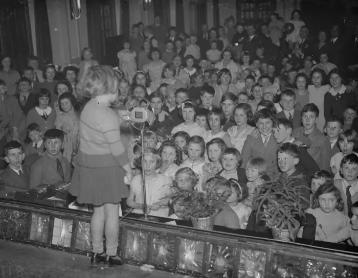 Framed Print : A little girl entertains the audience of children at the childrens party Framed Print : A little girl entertains the audience of children at the childrens party