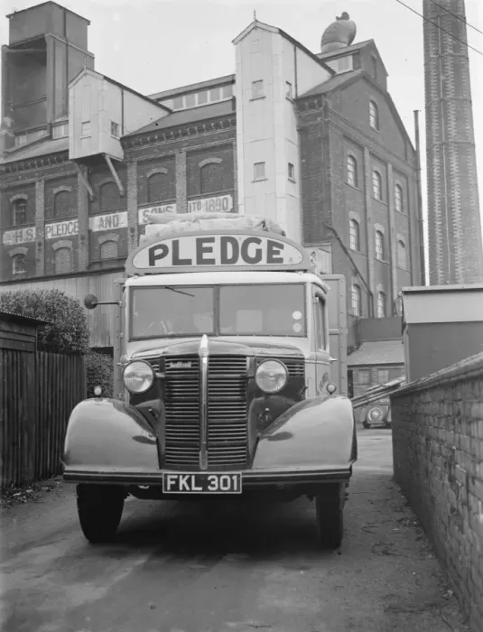 Framed Print : A loaded Bedford truck belonging to Pledge & Son Ltd, the milling company, pulls Framed Print : A loaded Bedford truck belonging to Pledge & Son Ltd, the milling company, pulls