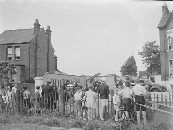 Locals gather at the site of the timber yard fire in Bexleyheath, Kent