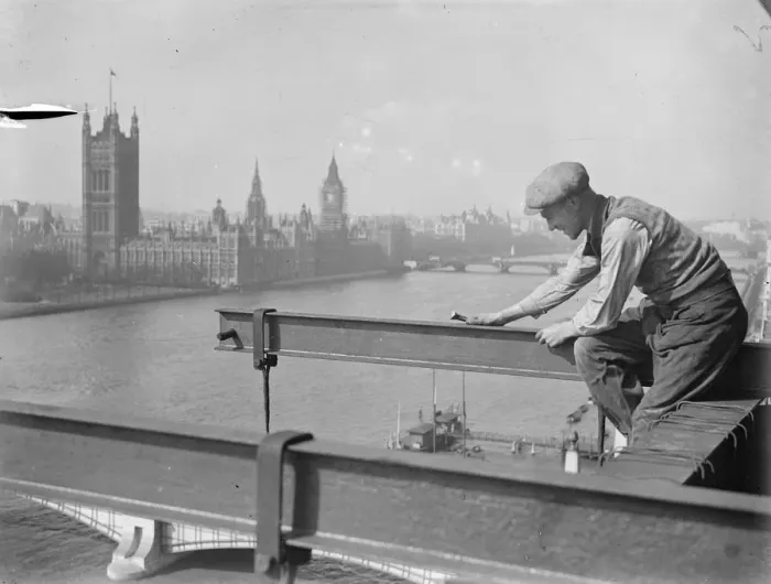 Framed Print : He looks down on Parliament. A welder on a precarious perch high above the Albert Embankment Framed Print : He looks down on Parliament. A welder on a precarious perch high above the Albert Embankment
