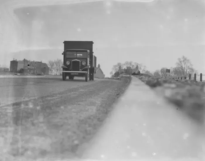 Framed Print : A lorry drives down the road - seen from the curb edge. 1936 Framed Print : A lorry drives down the road - seen from the curb edge. 1936