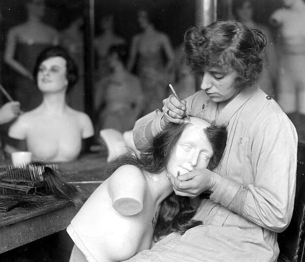 The making of wax models at Sages, Grays Inn Road. Attaching silken tresses to the scalp